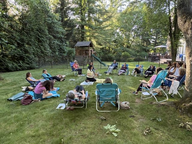 A group seated in a circle outdoors for a sound-healing session