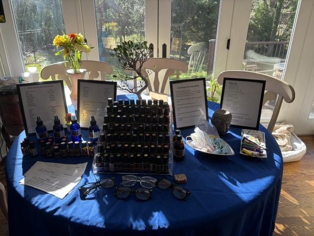 A table of essential oils and a sound bowl set for a workshop